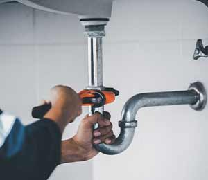 plumber fixing a drain